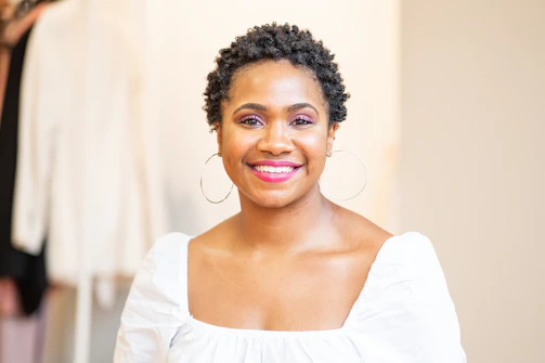 Professional headshot of a smiling woman, styled for brand leadership portrait