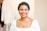 woman in white scoop neck shirt smiling