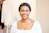 woman in white scoop neck shirt smiling