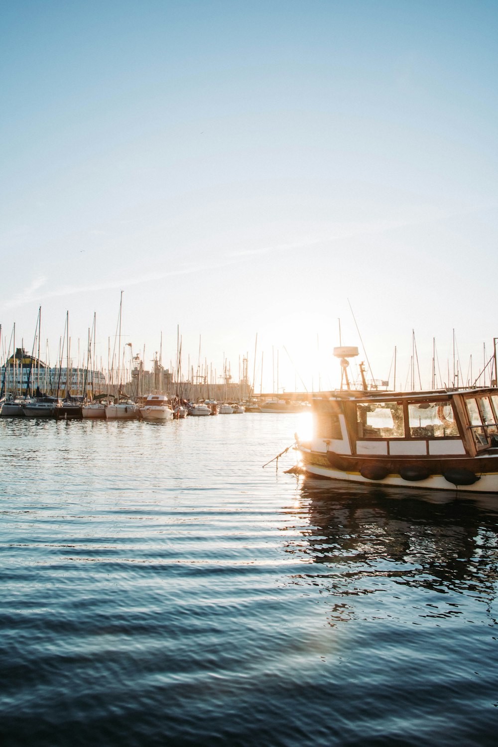 white and brown boat on body of water during daytime