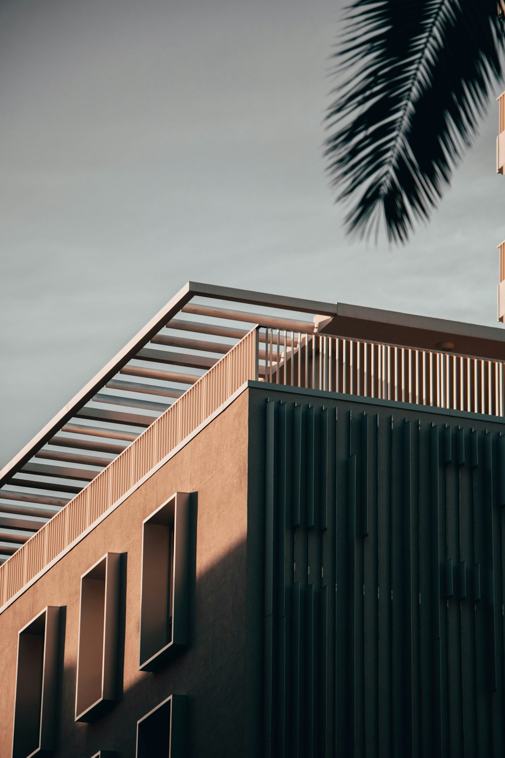 brown and black concrete building under gray sky