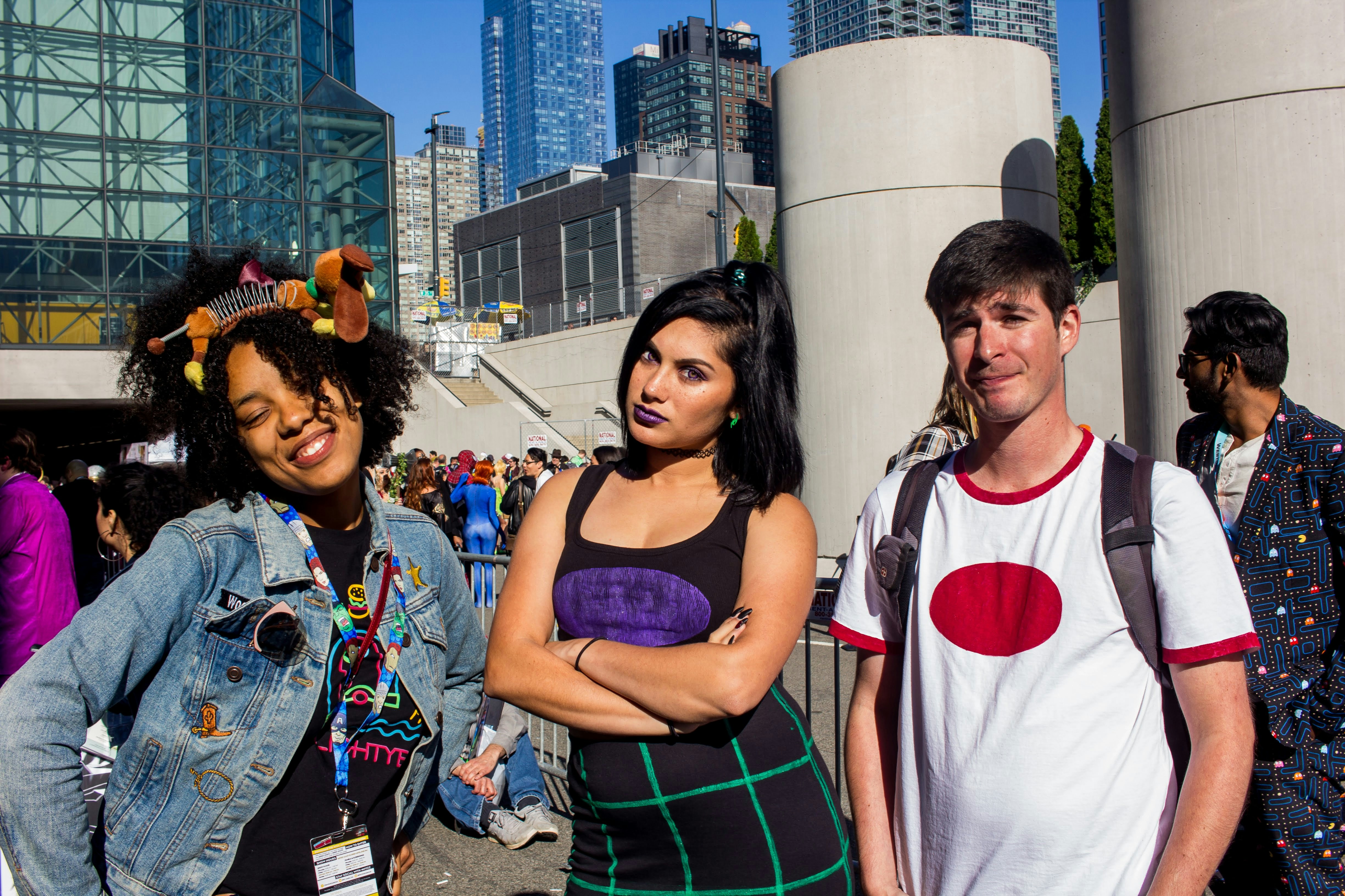 man in white tank top standing beside woman in pink tank top