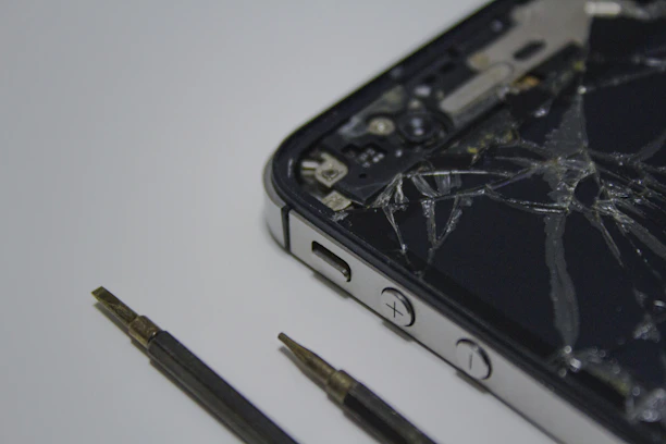A sleek smartphone with its screen displaying a repair progress bar on a clean workbench.