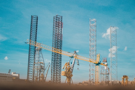 three yellow crane under blue sky during daytime in Senglea Malta