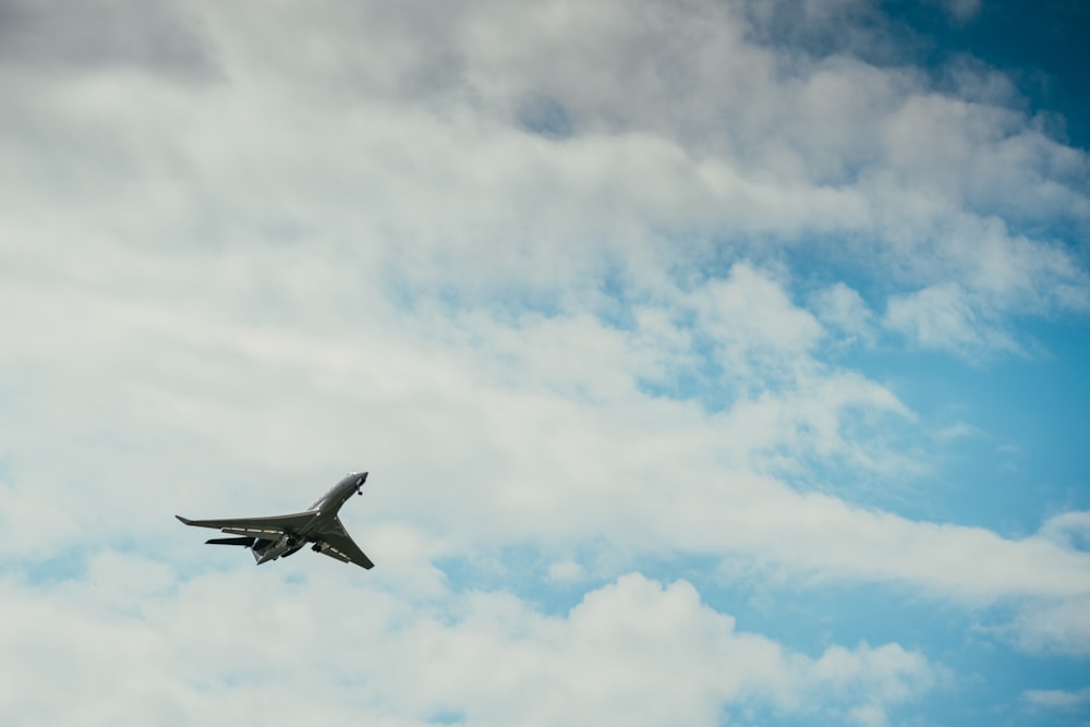 white airplane flying in the sky during daytime