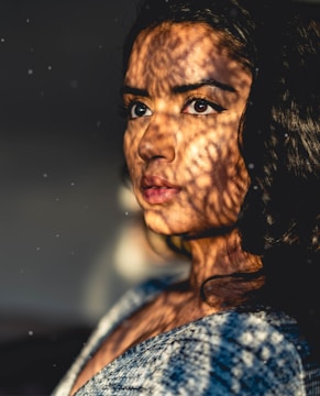 Portrait of a woman with expressive eyes and soft shadows.