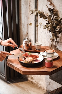 A cozy café setting with a table set for a gourmet meal.