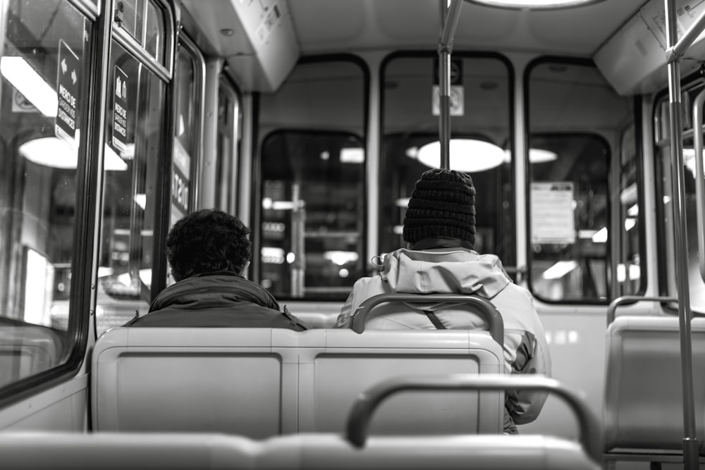 man in black knit cap sitting on bus seat