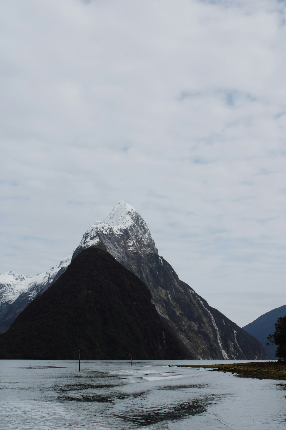 snow covered mountain under white clouds during daytime