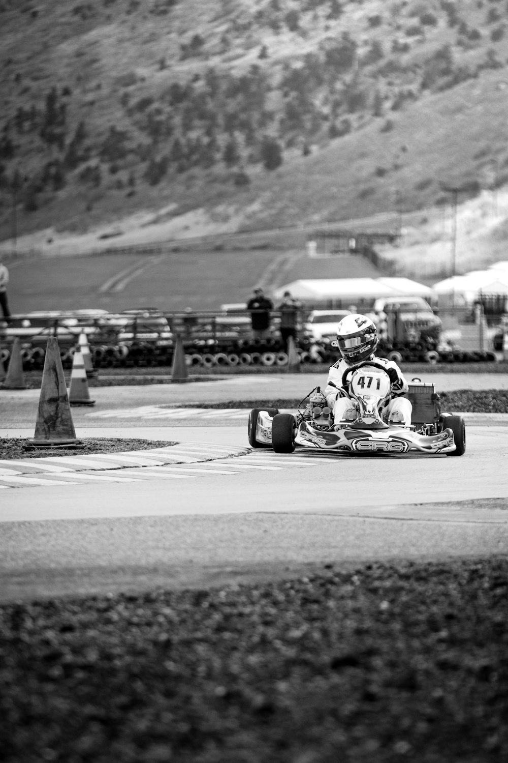 grayscale photo of person riding on go kart