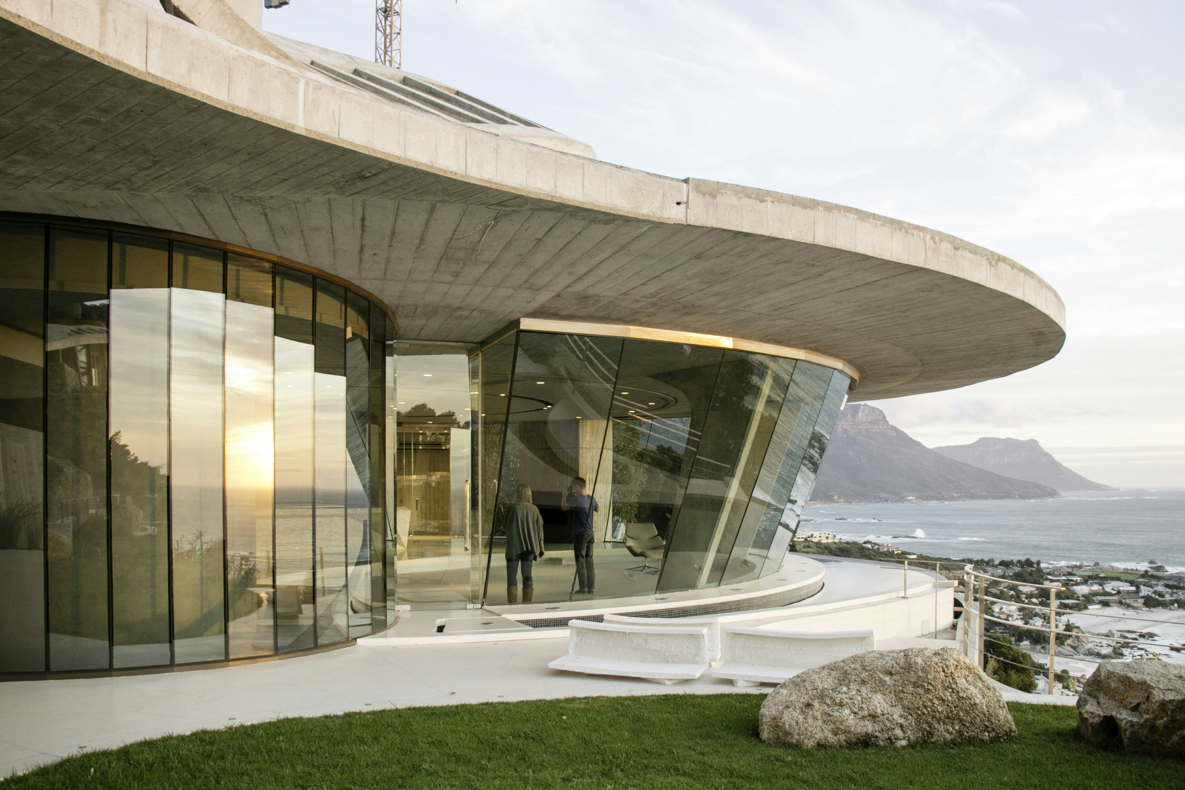 Modern concrete home overlooking the ocean and mountains.