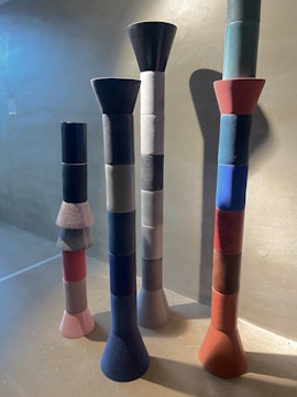 Abstract sculptures arranged in a bright gallery space.