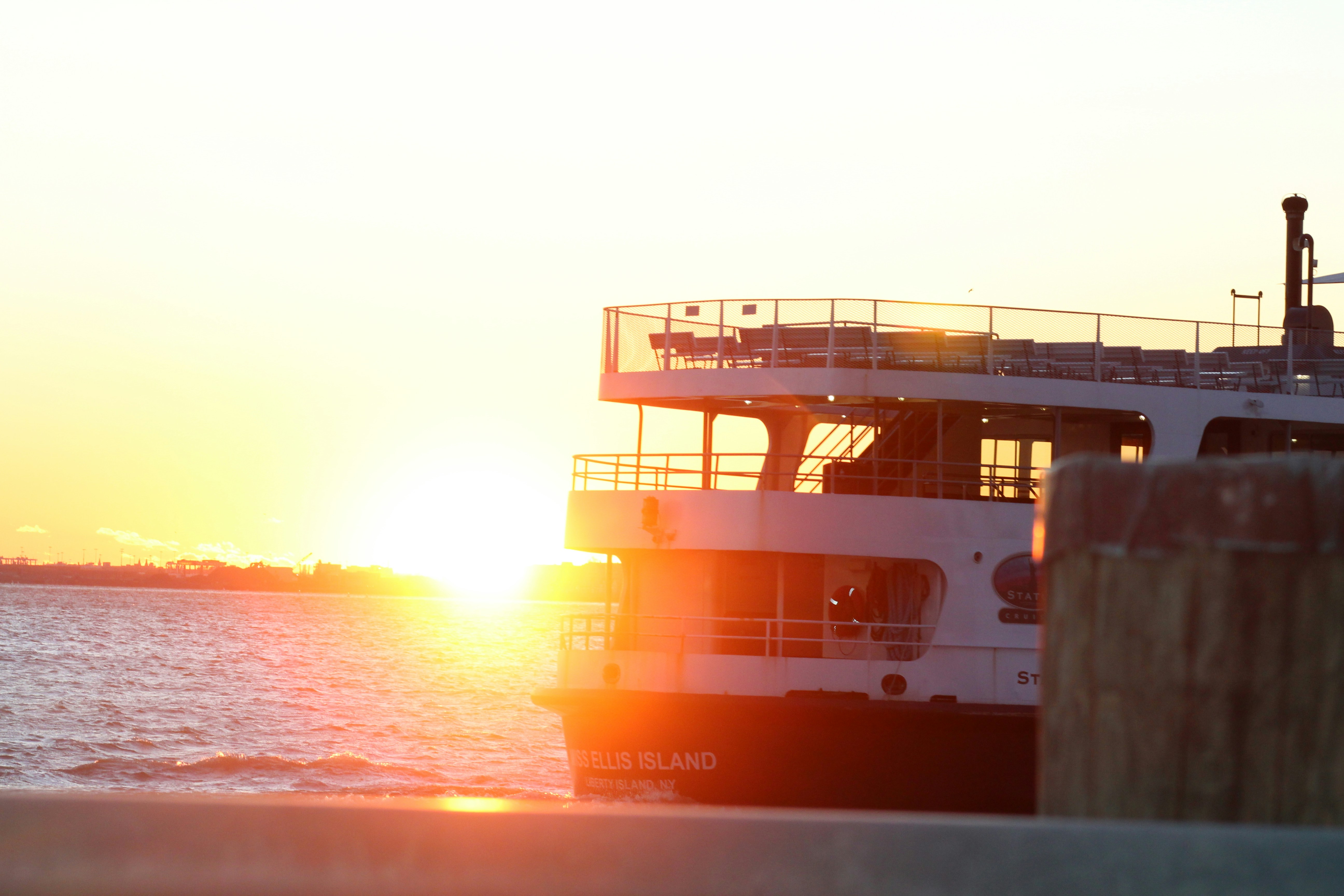 white and red ship on sea during sunset