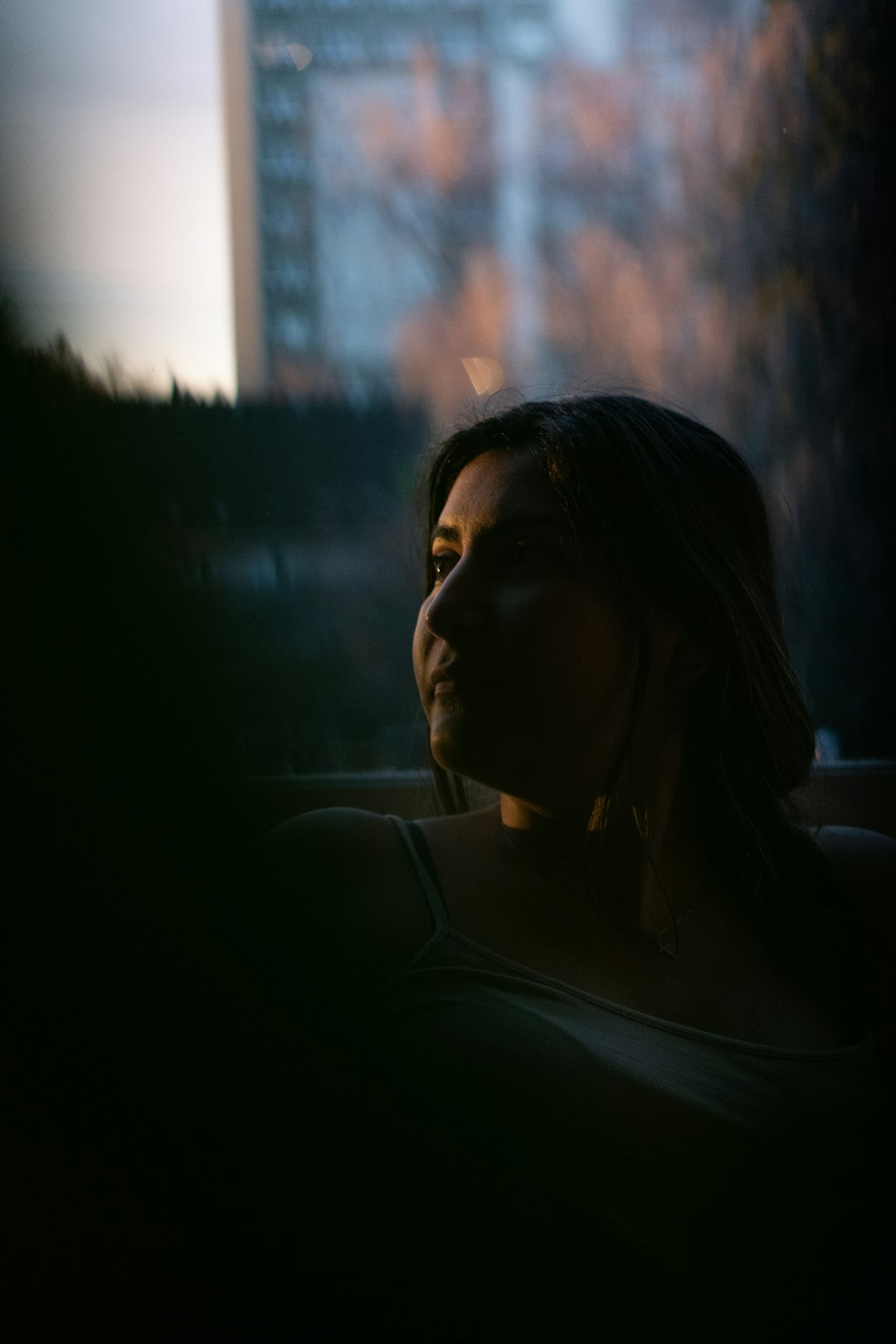 woman in white shirt looking at the sun