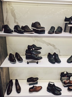 assorted shoes on white wooden shelf