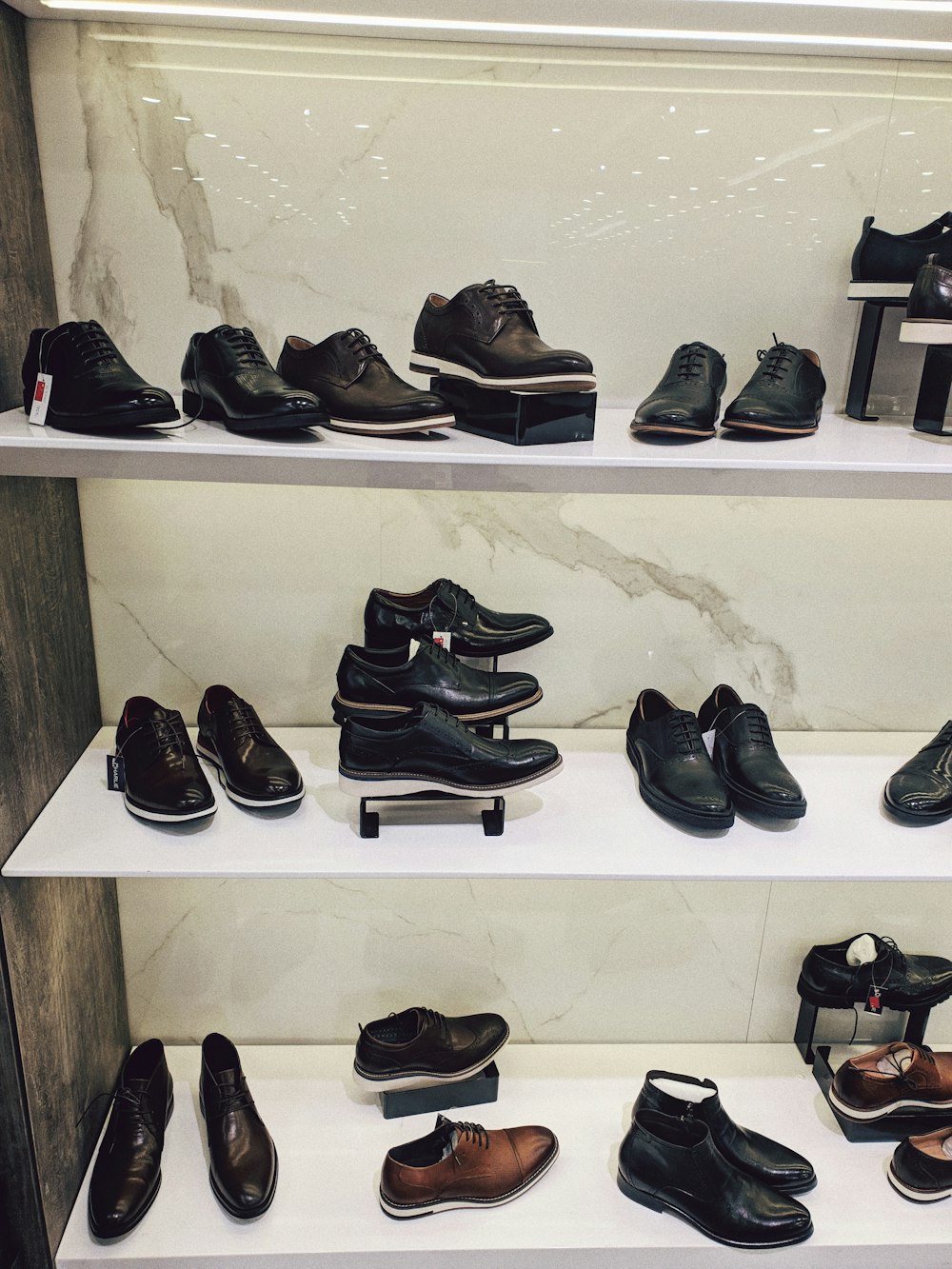 assorted shoes on white wooden shelf