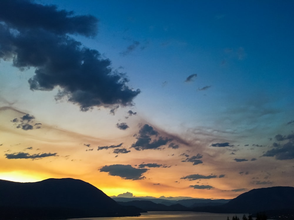 silhouette of mountain under blue sky during sunset