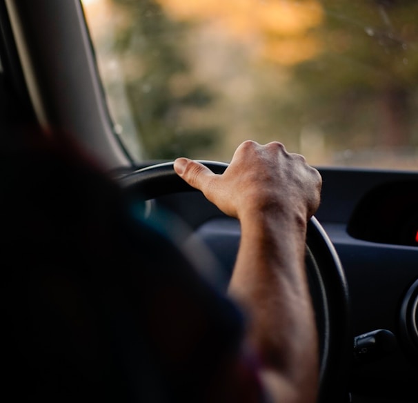 person driving car during daytime