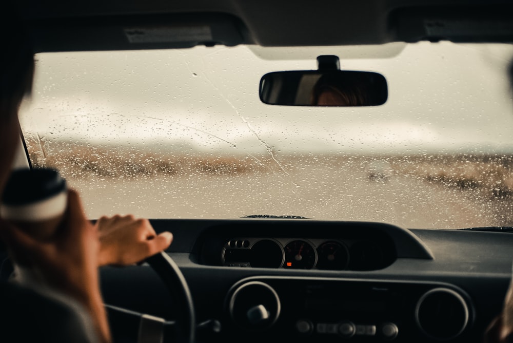 person driving car during daytime