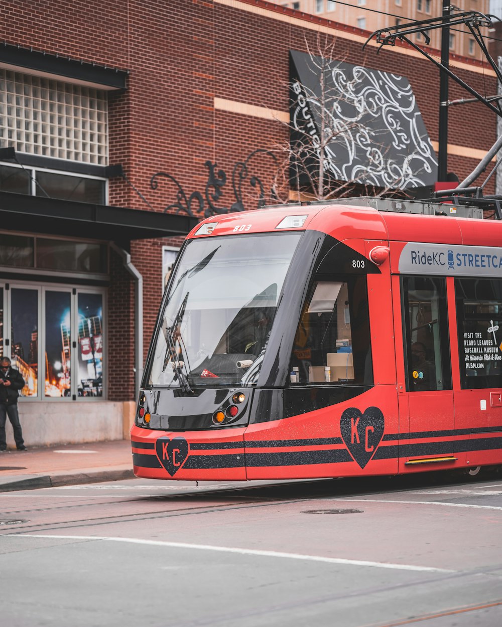 red and white tram on road during daytime