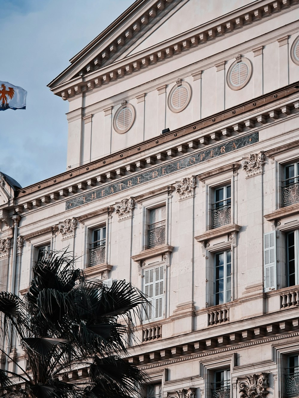 white concrete building with flag on top