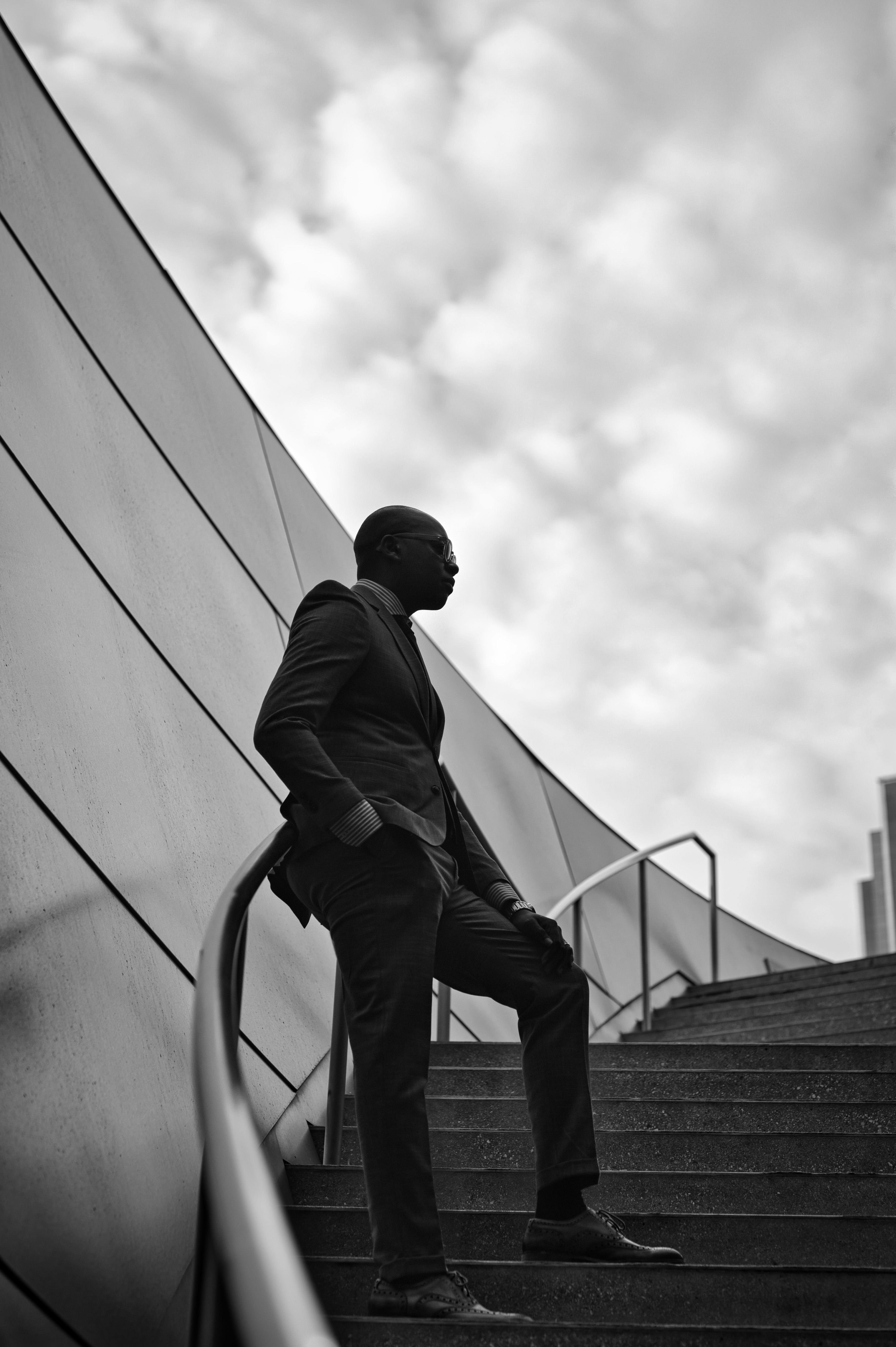 man in black jacket and black pants walking on stairs