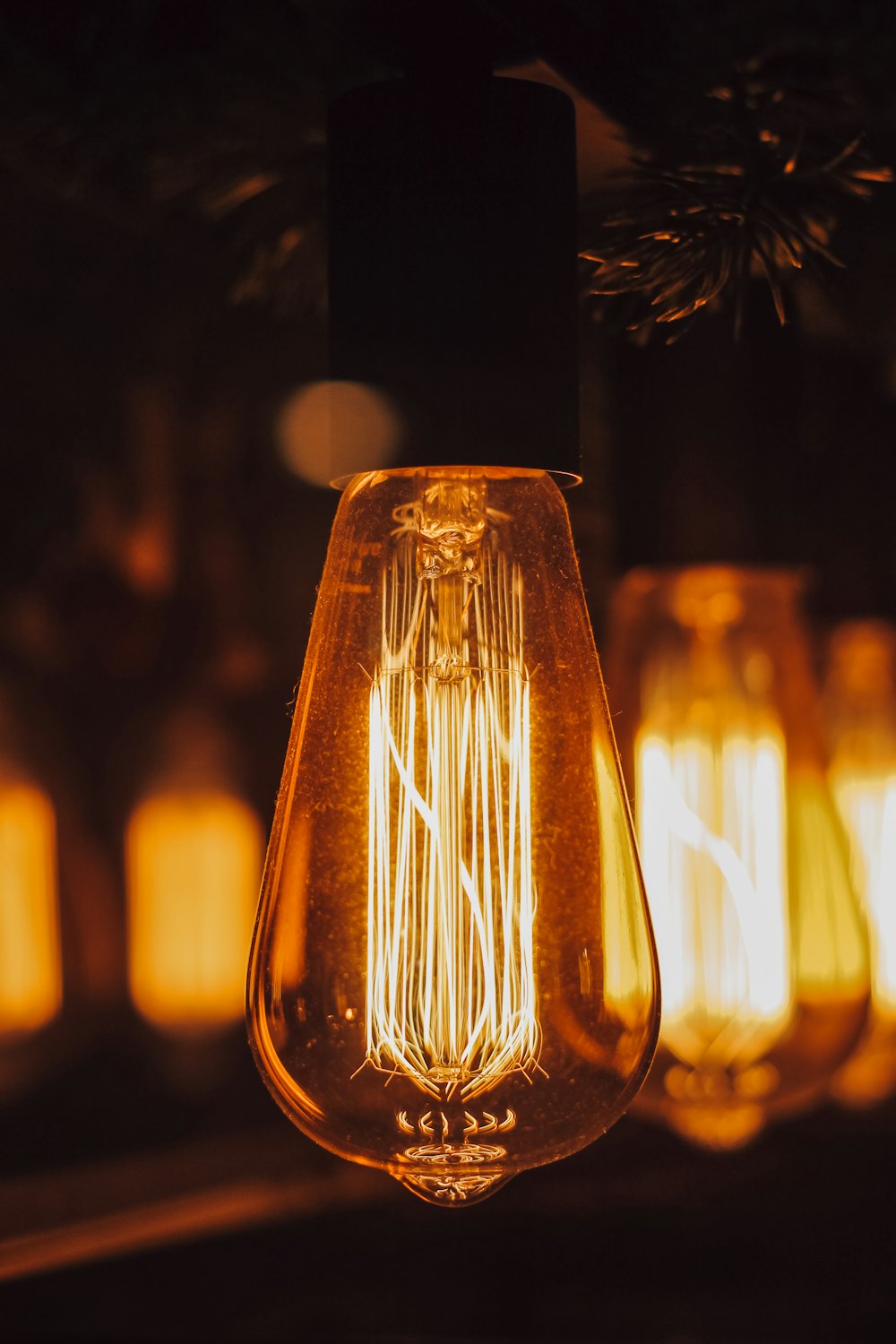 clear glass light bulb turned on in close up photography