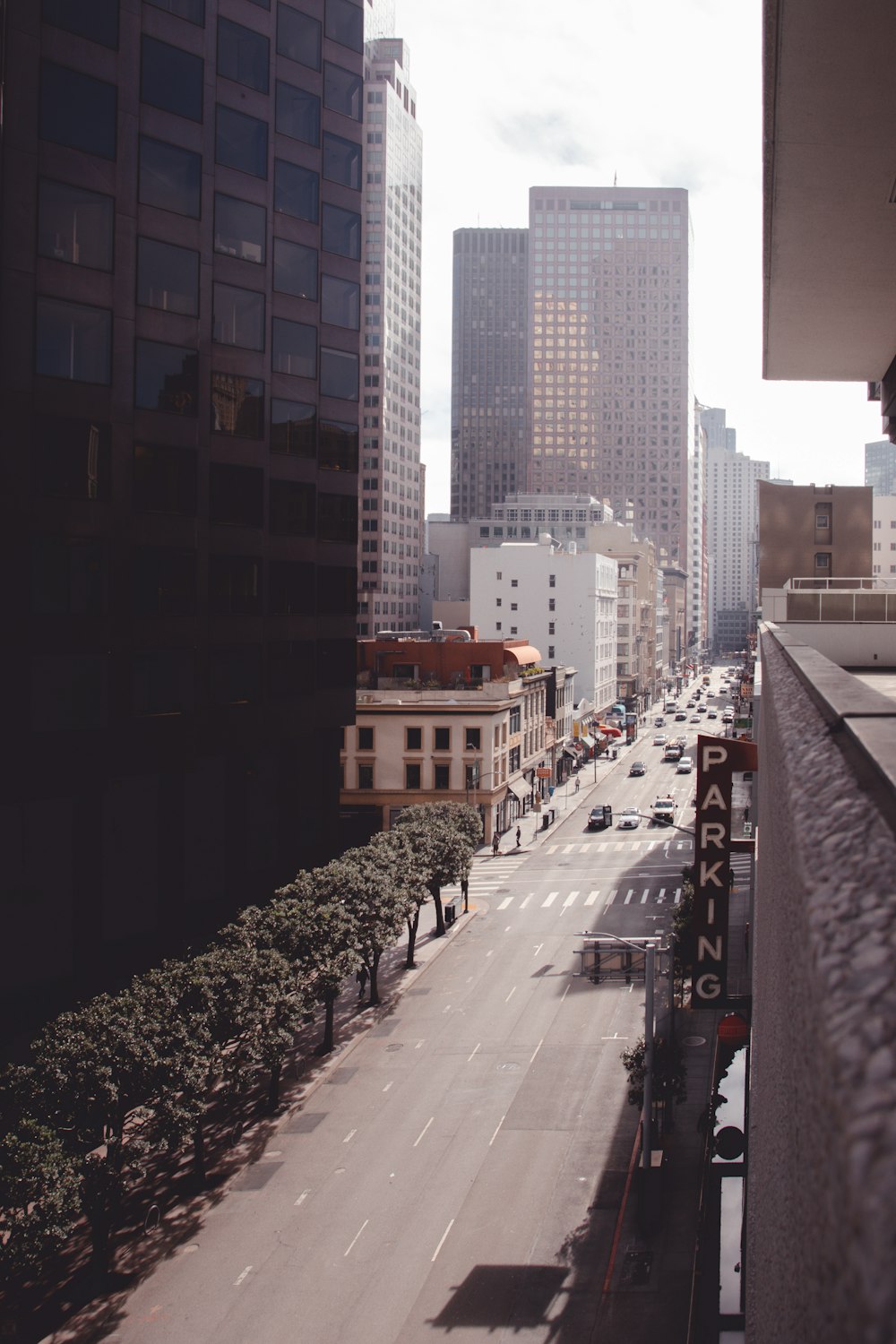 people walking on sidewalk near high rise buildings during daytime