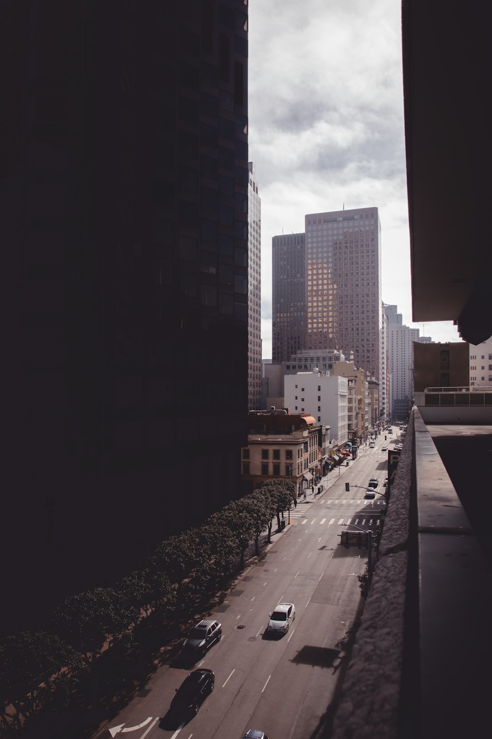 people walking on sidewalk near high rise buildings during daytime