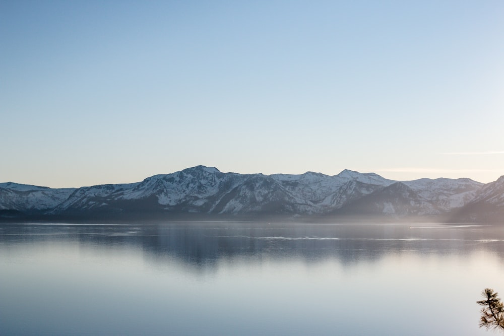 lake near snow covered mountain during daytime