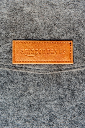 a close up of a leather label on a gray surface
