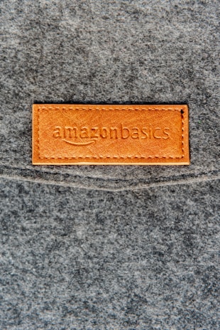 a close up of a leather label on a gray surface