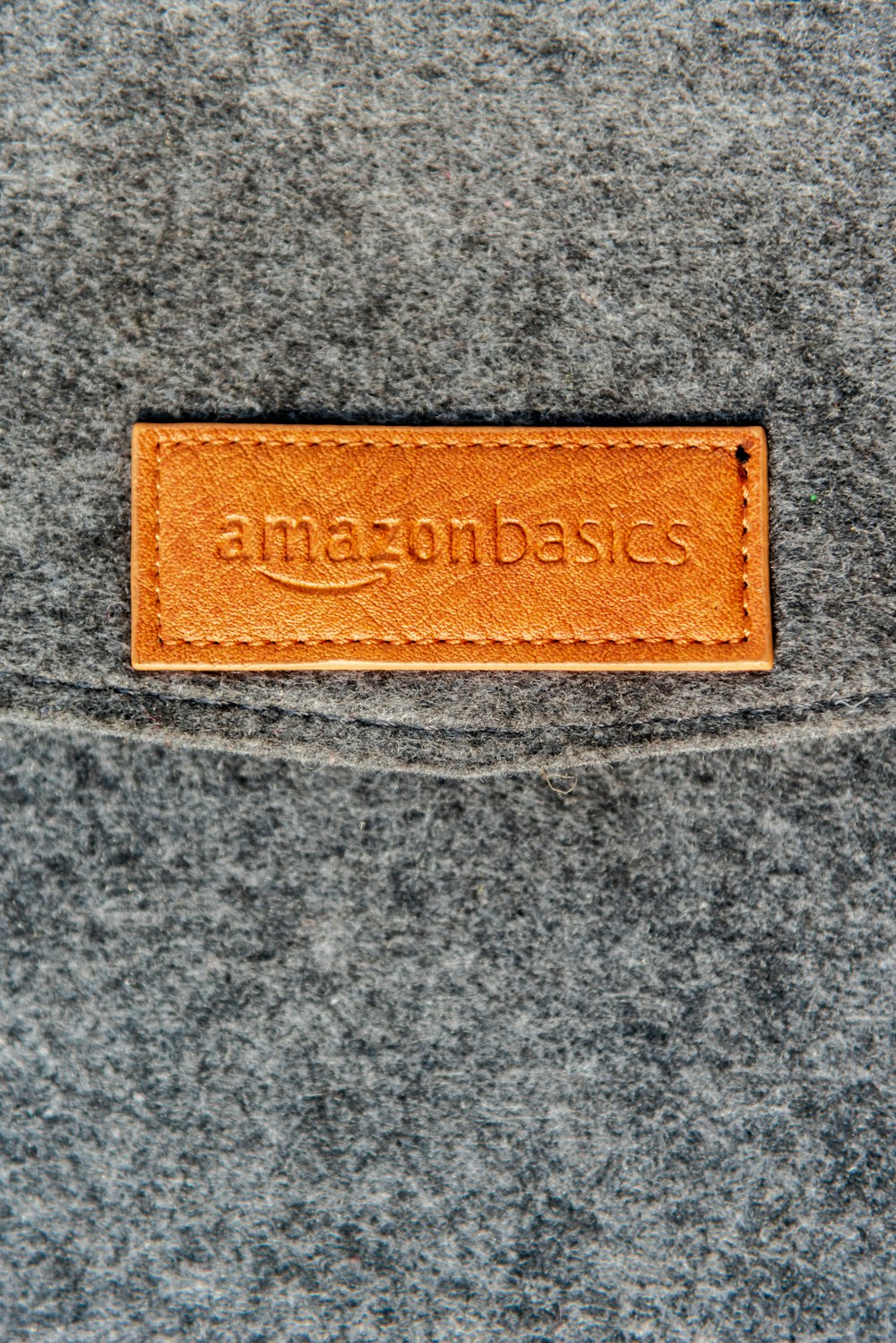 a close up of a leather label on a gray surface