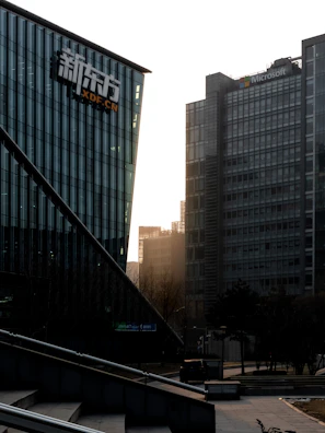 A vibrant collage featuring Microsoft, Lenovo, and Europcar logos against a dynamic cityscape.