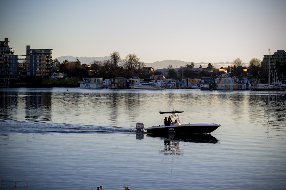 man in white shirt riding on white and black boat on water during daytime