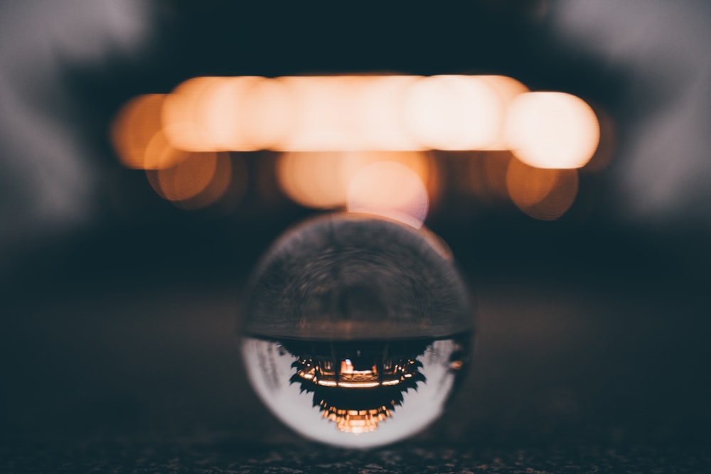 clear glass ball on black surface