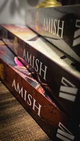 Stack of 3WM Press books with inviting covers displayed on a rustic shelf.