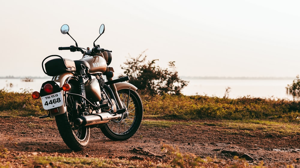 black motorcycle on brown grass field during daytime