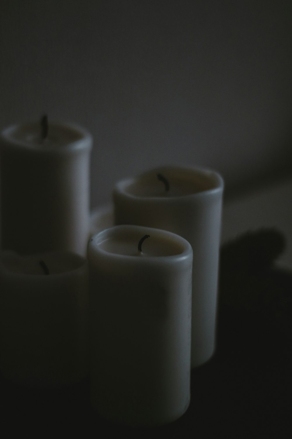 white pillar candles on white surface