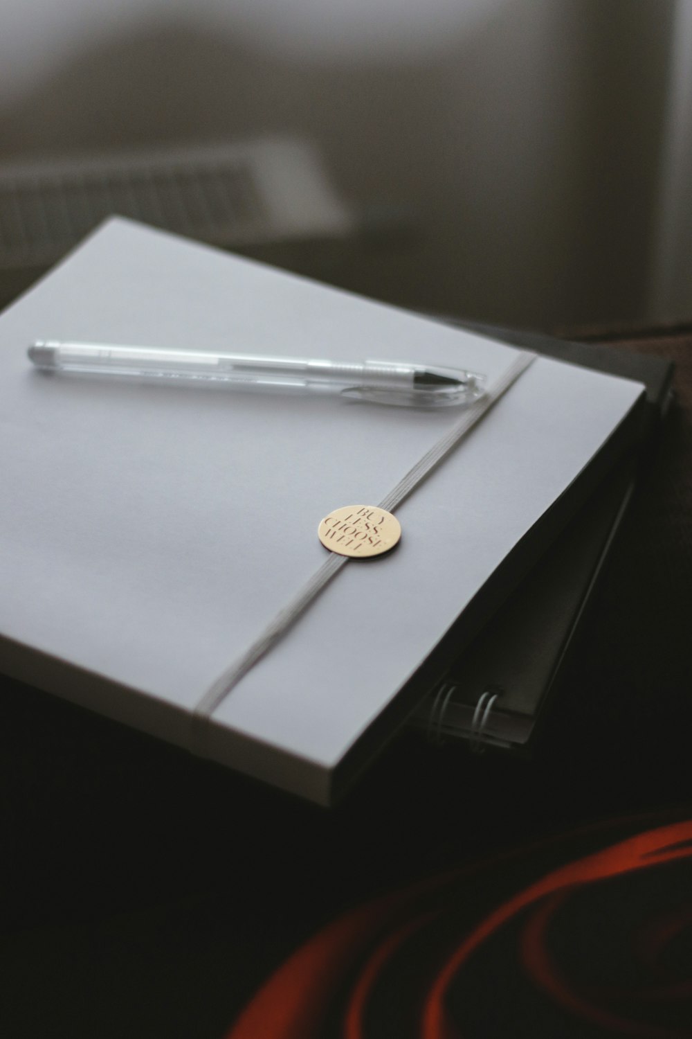 silver round coin on white paper