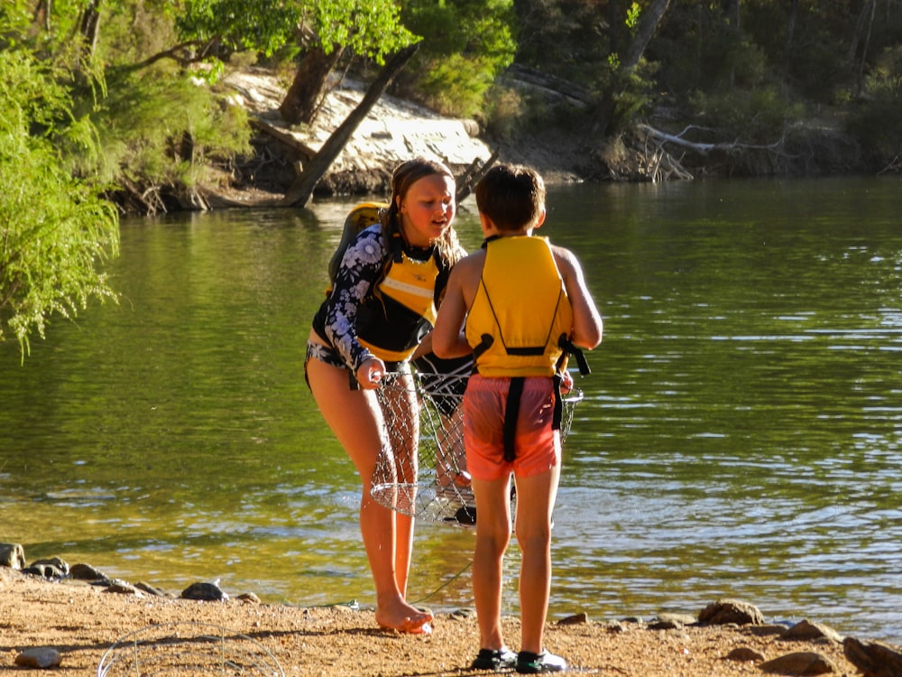 2 women standing on shore during daytime