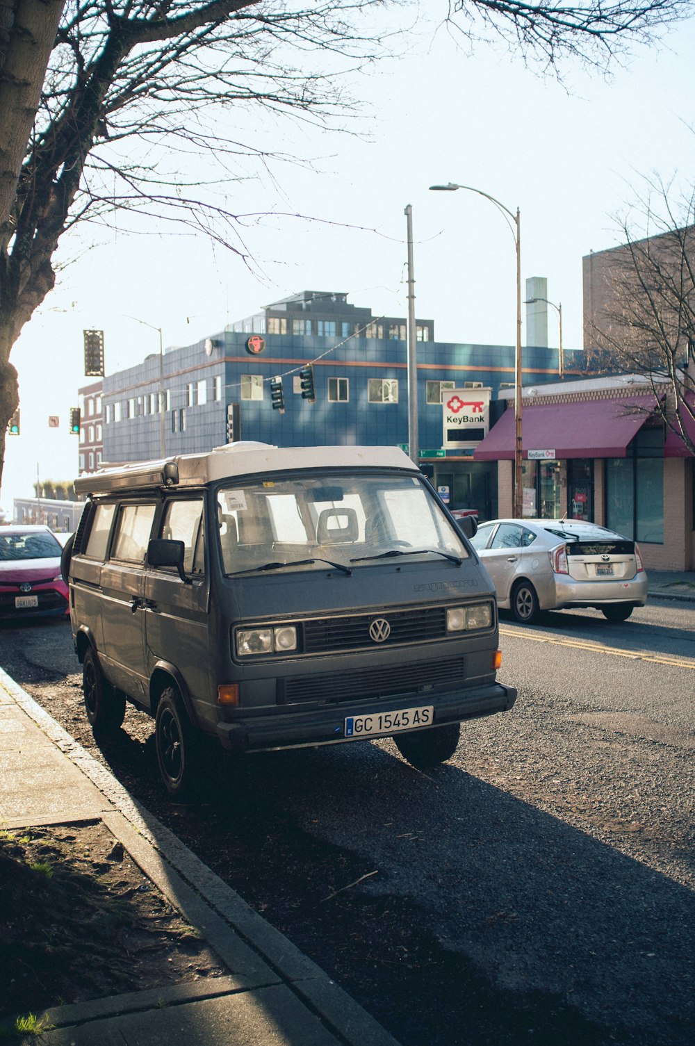 blue suv parked on sidewalk during daytime