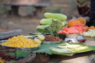 An assortment of exotic tropical vegetables arranged on a rustic wooden table.