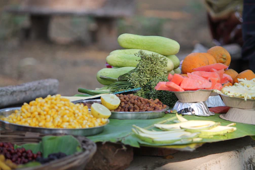 A nutrition counselor warmly chatting with a client over fresh fruits and vegetables on a kitchen table.