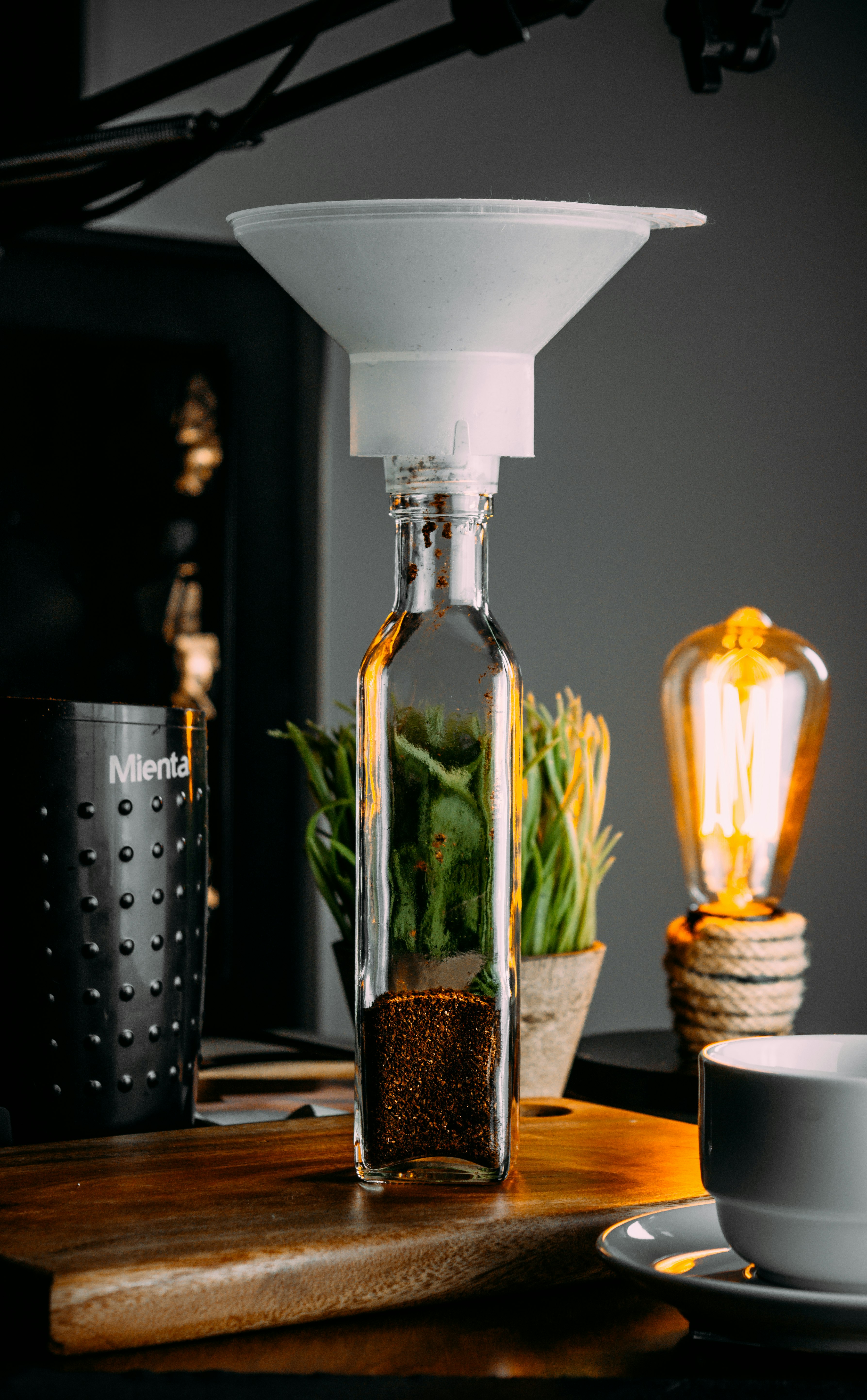 clear glass bottle with yellow liquid inside