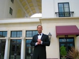 A well-dressed man showcasing a classic tuxedo at an event.