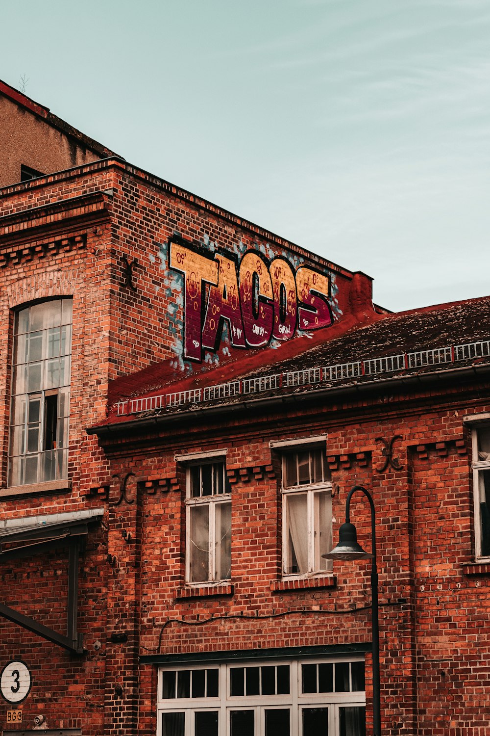 brown brick building under white sky during daytime