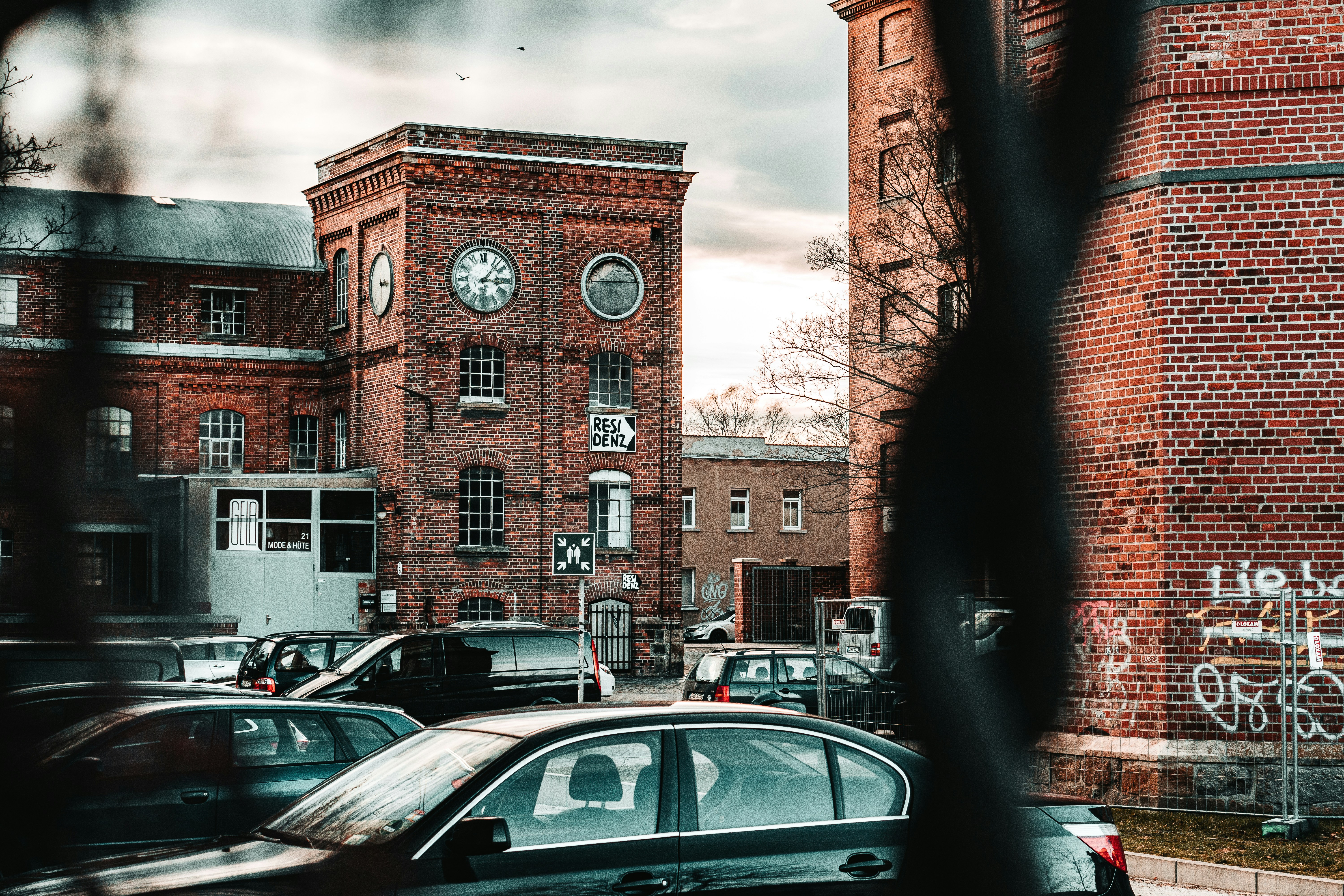 cars parked in front of brown concrete building during daytime