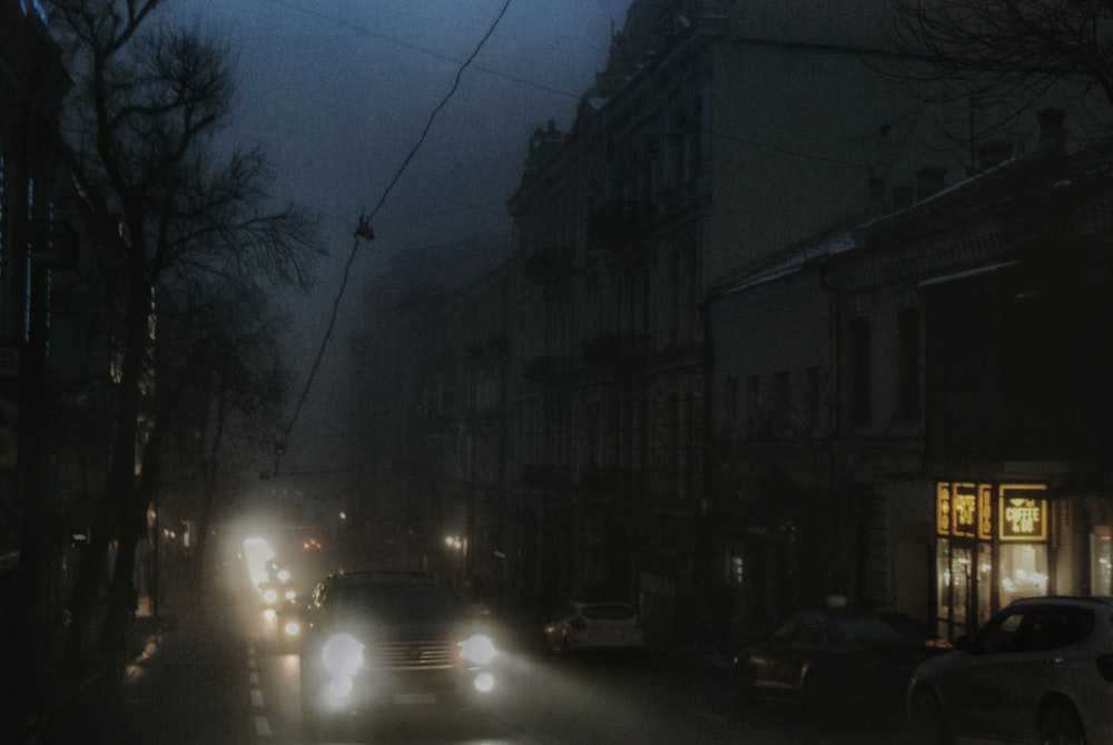 cars on road near buildings during night time