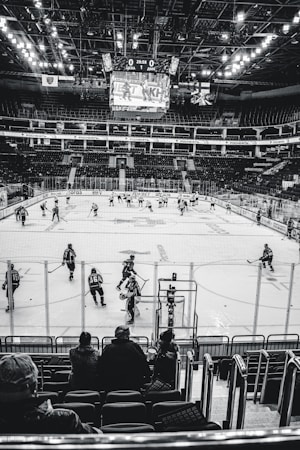 Empty arena seating bowl before a hockey game with the ice sheet lit below